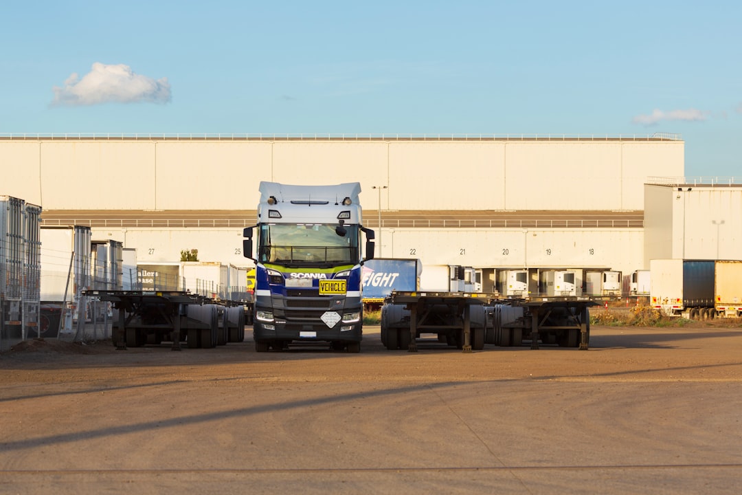 International freight trucks and trailers at a logistics warehouse